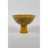 A Chinese yellow ground porcelain stem bowl with red and blue floral decoration, 6 character mark to