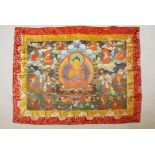 A Tibetan printed Thangka with embroidered silk borders, 44" x 33"