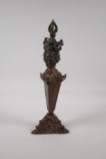 A Sino Tibetan ceremonial bronze phurba and stand with gilt patina, 12" high