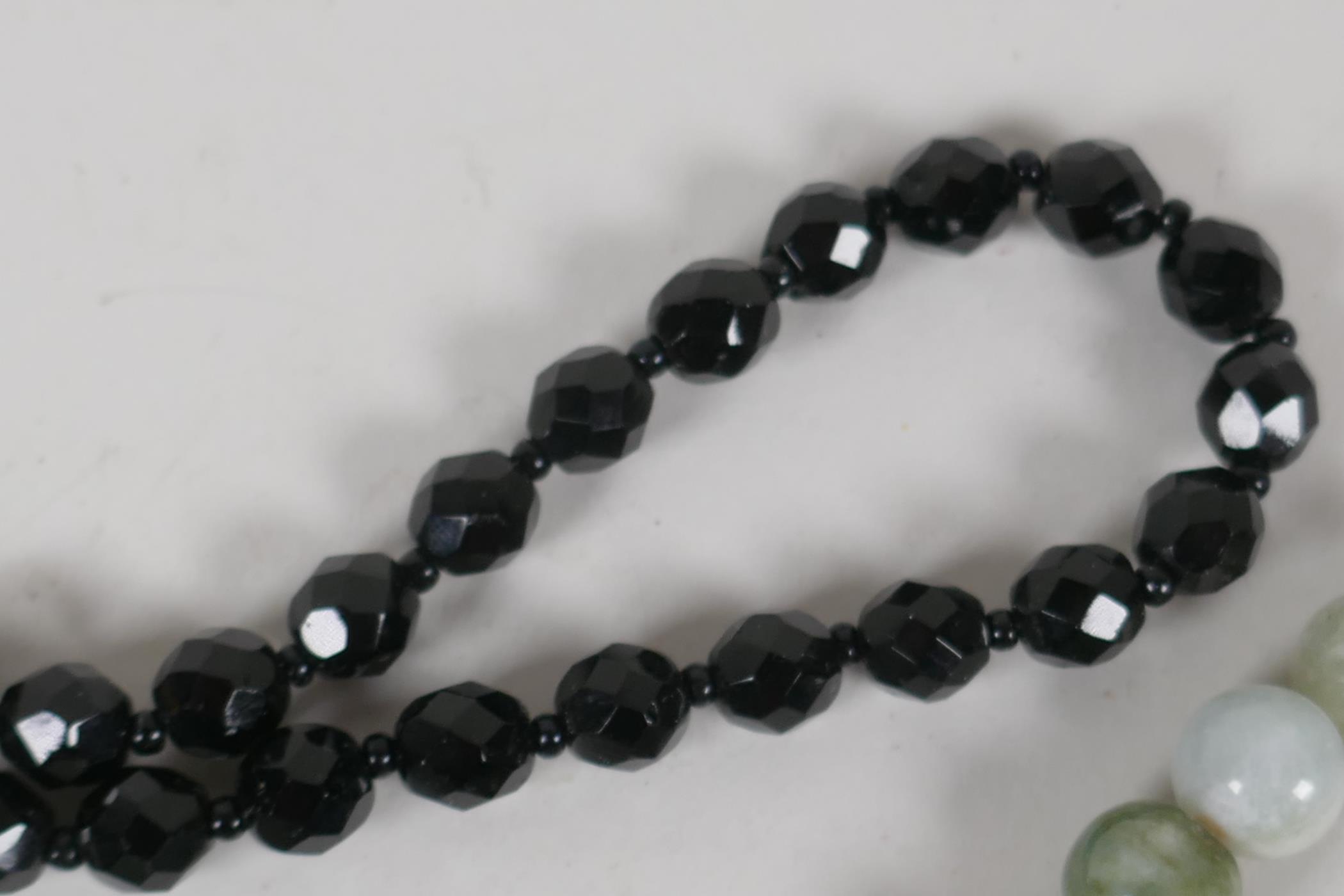 A jade bead necklace, 21½" long, together with a faceted french jet bead necklace, 16" long - Image 3 of 3