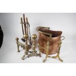 Two pairs of brass fire dogs, a copper coal scuttle, with brass handle and an Art Deco companion