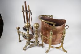 Two pairs of brass fire dogs, a copper coal scuttle, with brass handle and an Art Deco companion