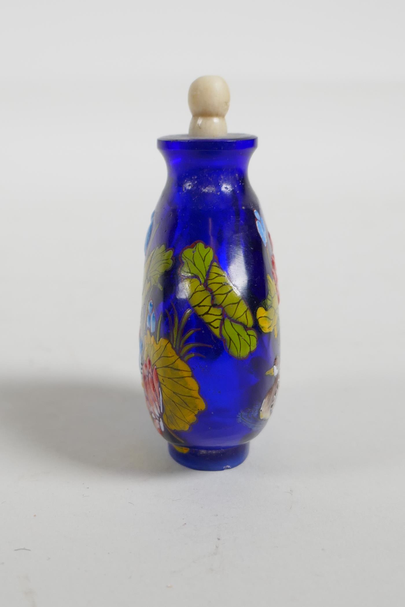 An enamelled blue Peking glass snuff bottle, decorated with waterfowl in a lotus pond, three - Image 2 of 5