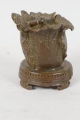 A small Chinese bronze candlestick, cast as a cabbage with insect on the top. 4 character mark to