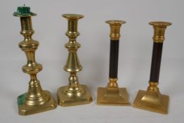 A pair of brass and wood candlesticks, 8" high and two C19th brass pusher candlesticks