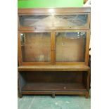 A 1930s oak three section stepped bookcase, 54" x 15" x 64"