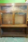 A 1930s oak three section stepped bookcase, 54" x 15" x 64"