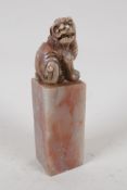A Chinese soapstone seal, the top carved as a Fo dog, 4" high