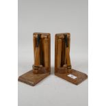 A pair of Art Deco oak bookends, in the form of a wicket, with cricket bat & ball, 8" high