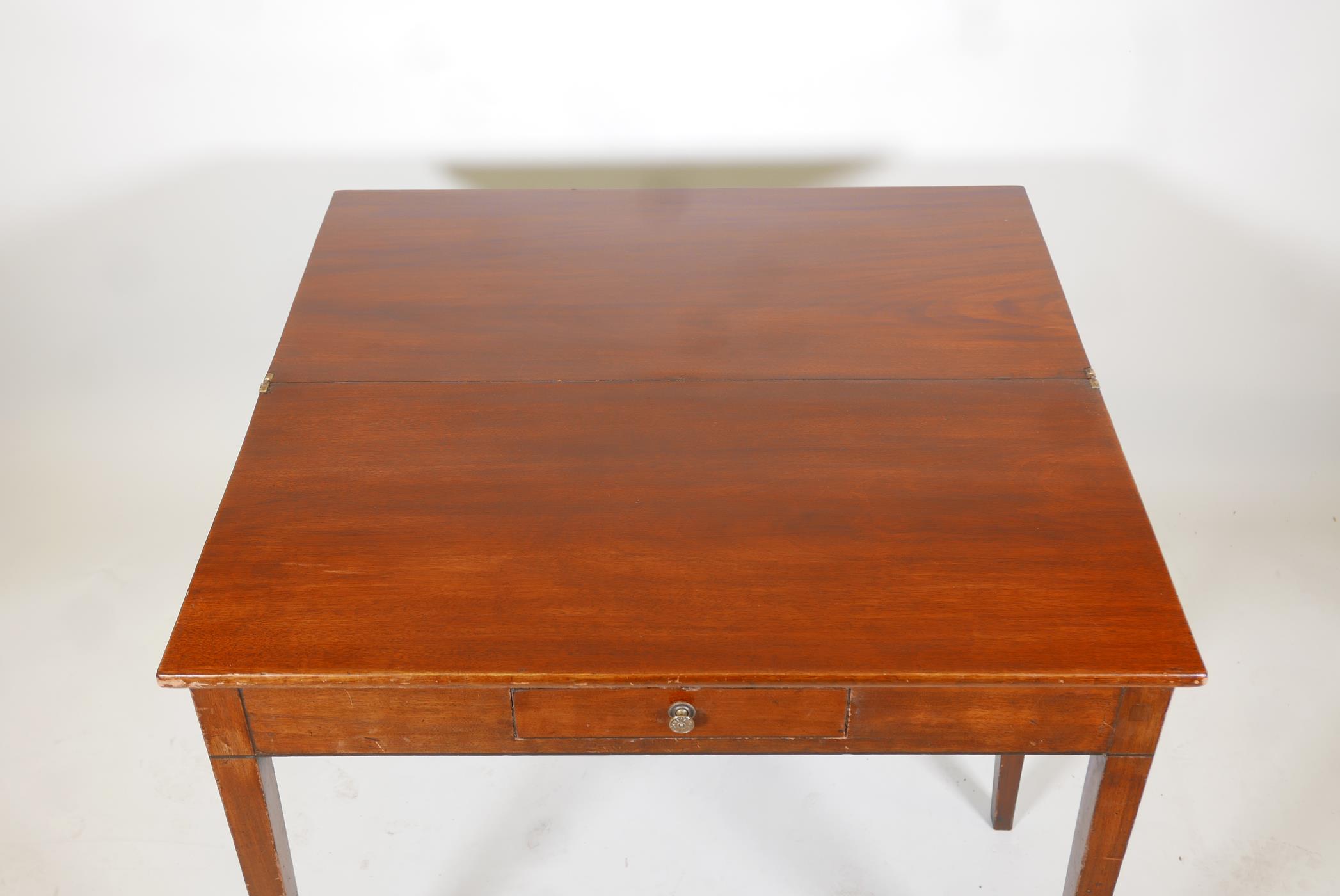 A Georgian III mark tea table with a fold over top and a single drawer, raised on square tapering - Image 3 of 4