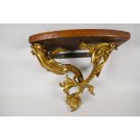 An ornate ormolu wall bracket, cast as scrolling leaves & having a walnut top. 12" deep x 13" wide