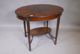 An Edwardian mahogany oval shaped centre table, with segmented flame veneered top, raised on