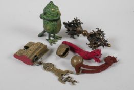 A Chinese brass padlock, two Indian brass bells, a Tibetan vajra and an inkwell in the form of a