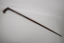 A hardwood walking stick with bone tip, a ferrule and carved handle. 35½"
