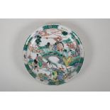 A famille verte porcelain charger decorated with warriors in a landscape, Chinese Kangxi 6 character