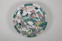 A famille verte porcelain charger decorated with warriors in a landscape, Chinese Kangxi 6 character