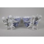 A pair of Parian ware table centrepiece bowls, in the form of cherubs pulling shell carts. 12" long