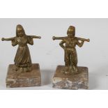 Two small brass/bronze figurines of Dutch Children, carrying yokes on their shoulders, mounted on
