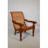 A hardwood and cane plantation chair on turned supports. 37" high