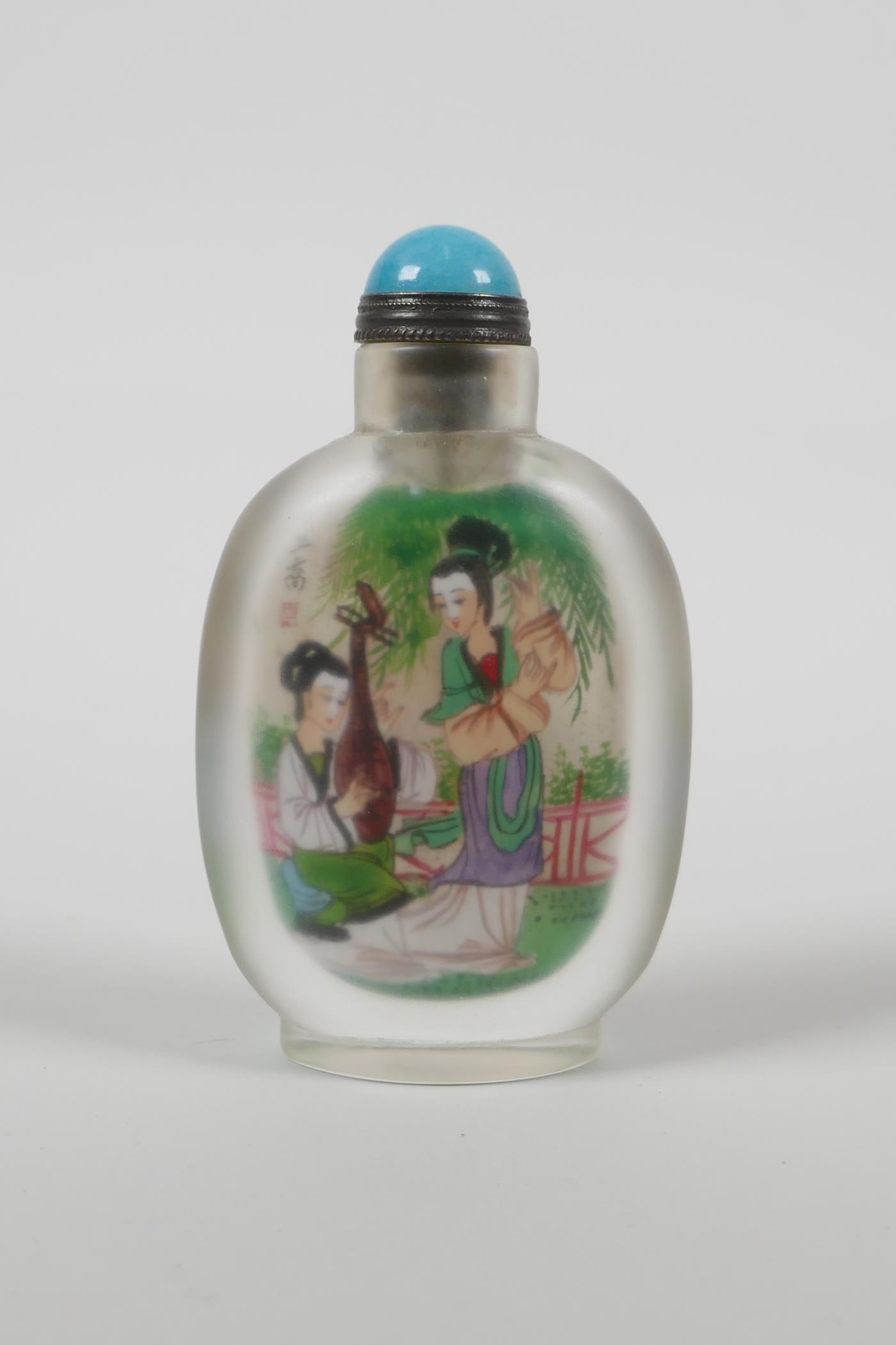 A Chinese reverse decorated glass snuff bottle depicting two women in a garden to each side, 3½"