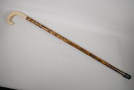A C19th Malacca walking cane, with woven metal ferrule. With broken bakelite tord to handle