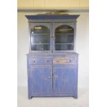 A painted pine dresser. With glazed upper section over two drawers and cupboard base. 76" x 49" x