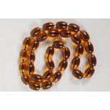 A faux amber bead necklace, 34" long
