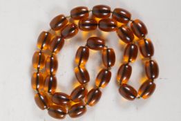 A faux amber bead necklace, 34" long