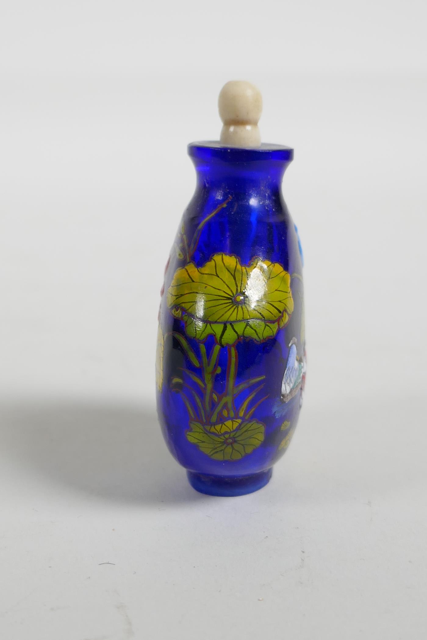 An enamelled blue Peking glass snuff bottle, decorated with waterfowl in a lotus pond, three - Image 4 of 5
