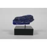 A lapis lazuli carving, in the form of the eye of RA, on a display mount, 2½" wide x 2" high