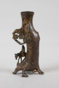 A Chinese bronze spill vase in the form of a traveller beneath a tree, with gilt patina, 6" high