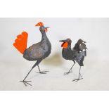 A painted iron sculpture of a cockerel and another of a chicken. 26" high