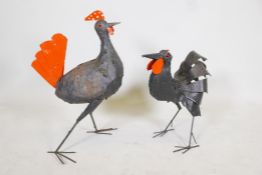 A painted iron sculpture of a cockerel and another of a chicken. 26" high
