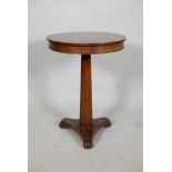 Regency mahogany occasional table with frieze top, raised on a tapering column and platform base