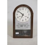 A Seiko 30 day wall clock, with date & day apertures. Complete with pendulum & key. 17" high