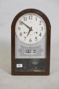 A Seiko 30 day wall clock, with date & day apertures. Complete with pendulum & key. 17" high