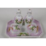 A C19th, continental, porcelain dressing table set. A tray, 10" x 7½". Two toilet water bottles