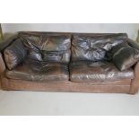 A brown leather three seater settee, 92" long