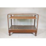 Antique mahogany glass top shop display cabinet, illuminated. Raised on square supports, with