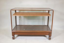 Antique mahogany glass top shop display cabinet, illuminated. Raised on square supports, with