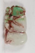 A Chinese green & white jade pendant, carved as a mythical creature, on a gourd. 2¼" long