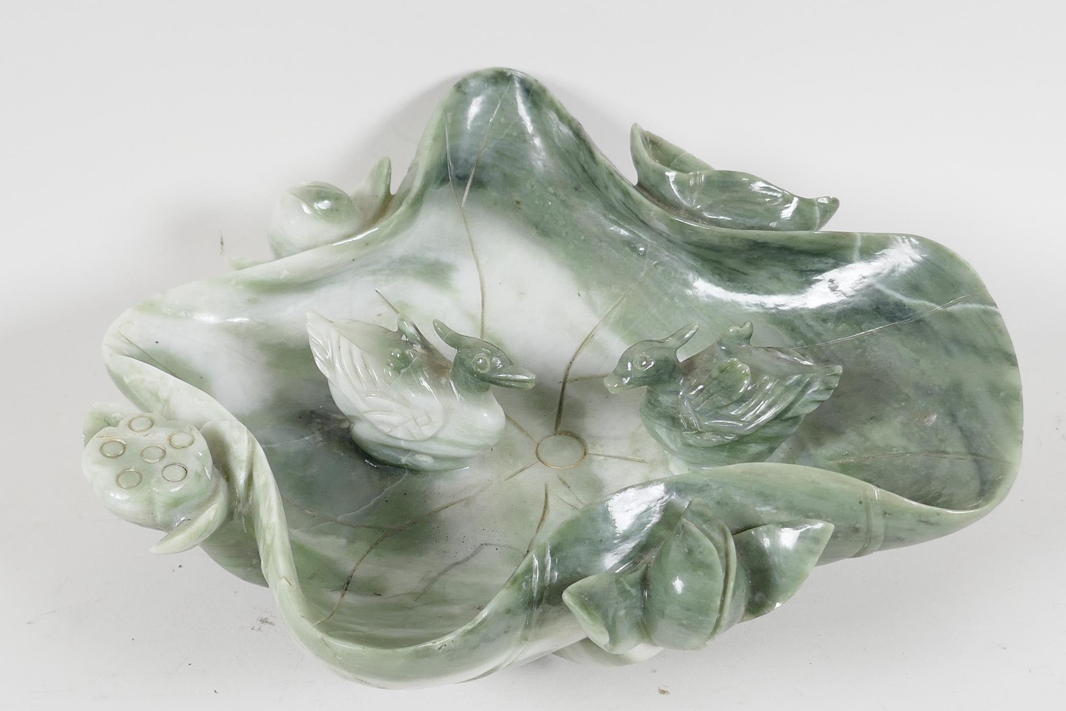 A Chinese Jade brush wash, carved as a large lotus leaf, with ducks, 9" wide