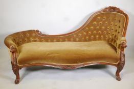 A Victorian button back walnut chaise longue with carved details and legs