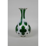 A Bohemian green glass vase, decorated with a slice pattern with gilt details, 8½" high