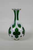 A Bohemian green glass vase, decorated with a slice pattern with gilt details, 8½" high