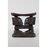 An African Luba carved hardwood figural headrest. 7½" wide x 7½" high