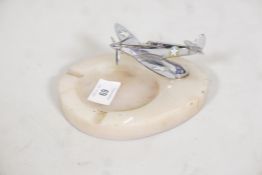 A vintage onyx ashtray, with chrome plated model of a spitfire fighter plane, 6" diameter