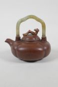 A Chinese Yixing teapot of lobed form with a celadon hardstone handle, the cover with a ruyi knop,