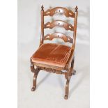 A C19th Gothic style walnut hall chair, with pierced bar back and carved decoration