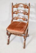 A C19th Gothic style walnut hall chair, with pierced bar back and carved decoration